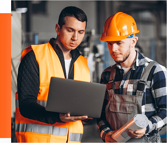 Certified heating technicians reviewing HVAC project data on laptop.